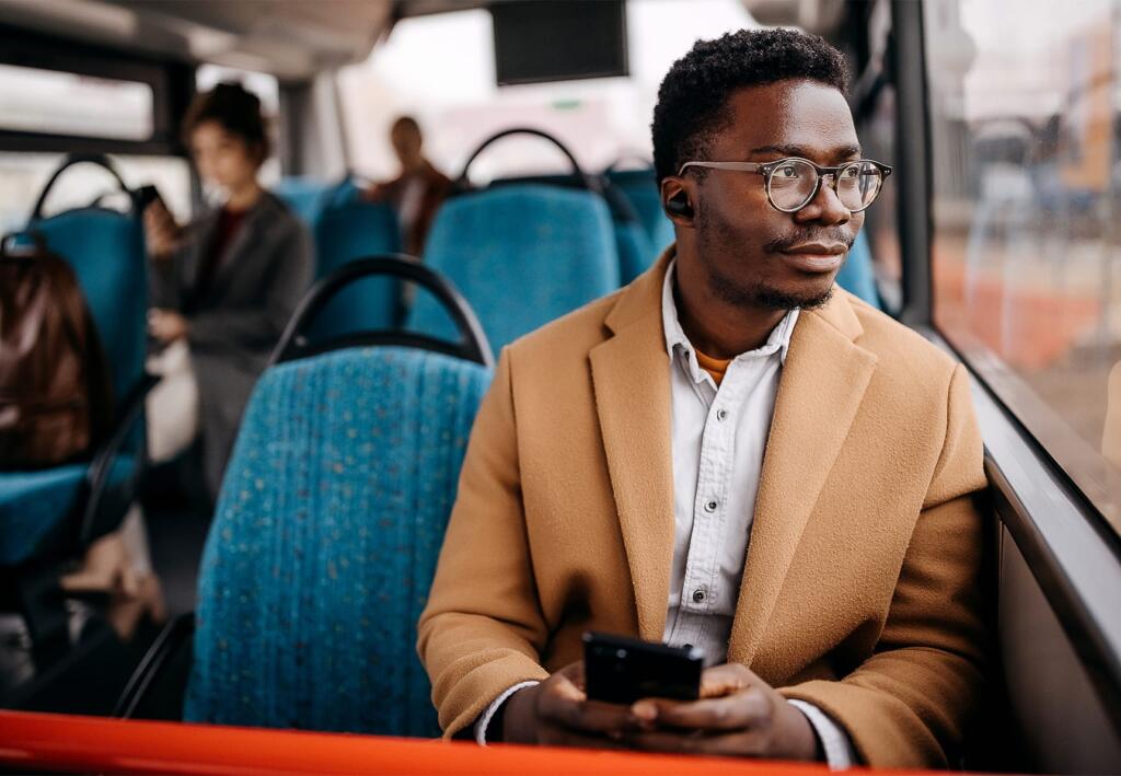 Person riding a bus looking out the window