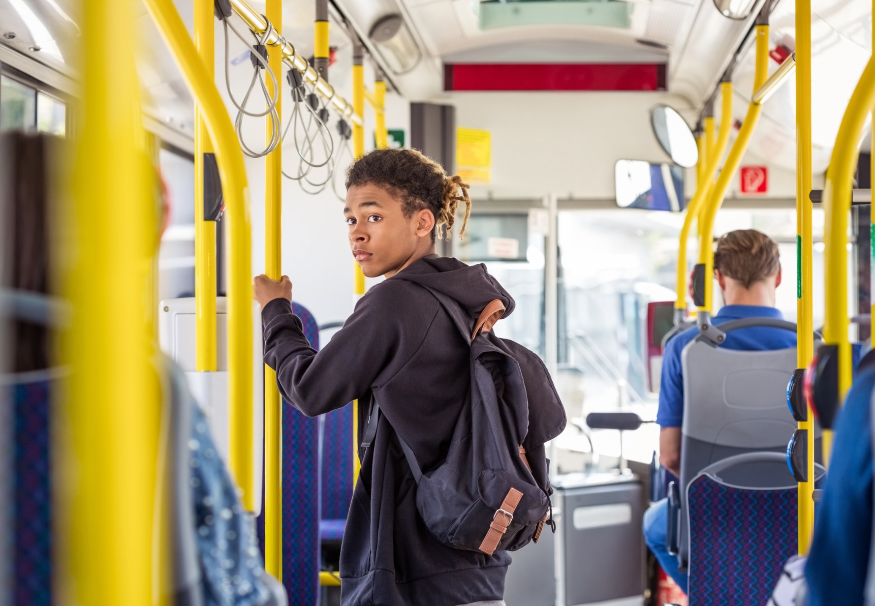 teenage boy riding a bus