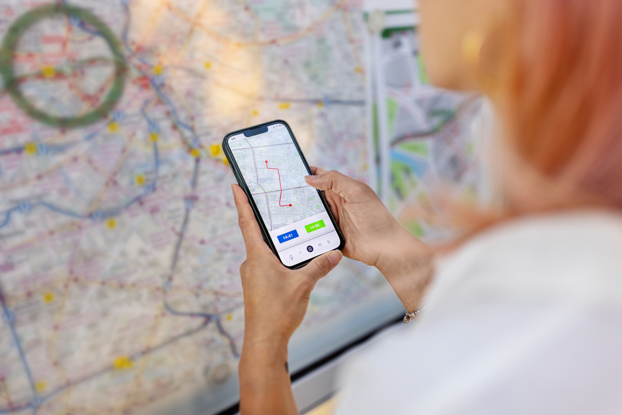 Woman looking at map on phone Internet of Things