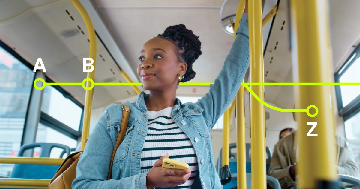 Black woman riding bus holding yellow smartphone