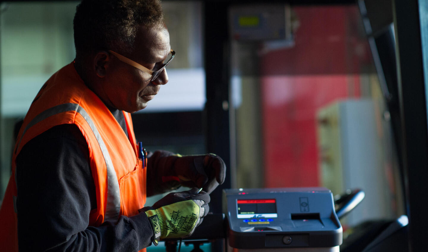 Operations staff maintains Fast Fare farebox on bus