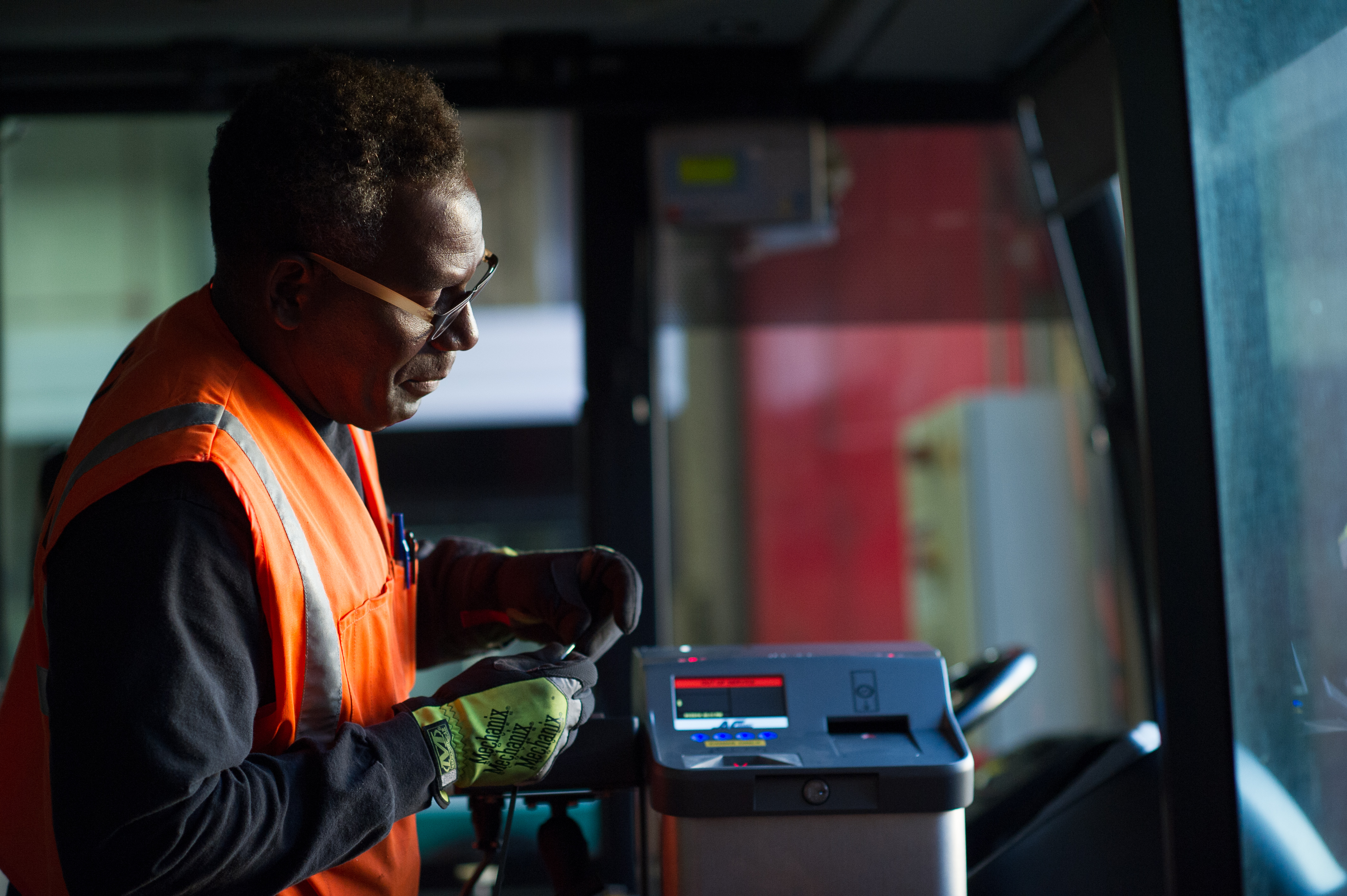 Operations staff maintains Fast Fare farebox on bus