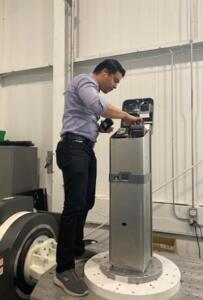 Rogelio Vicencio demonstrating Fast Fare farebox maintenance